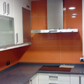 Cocina alicatada con azulejo naranja.