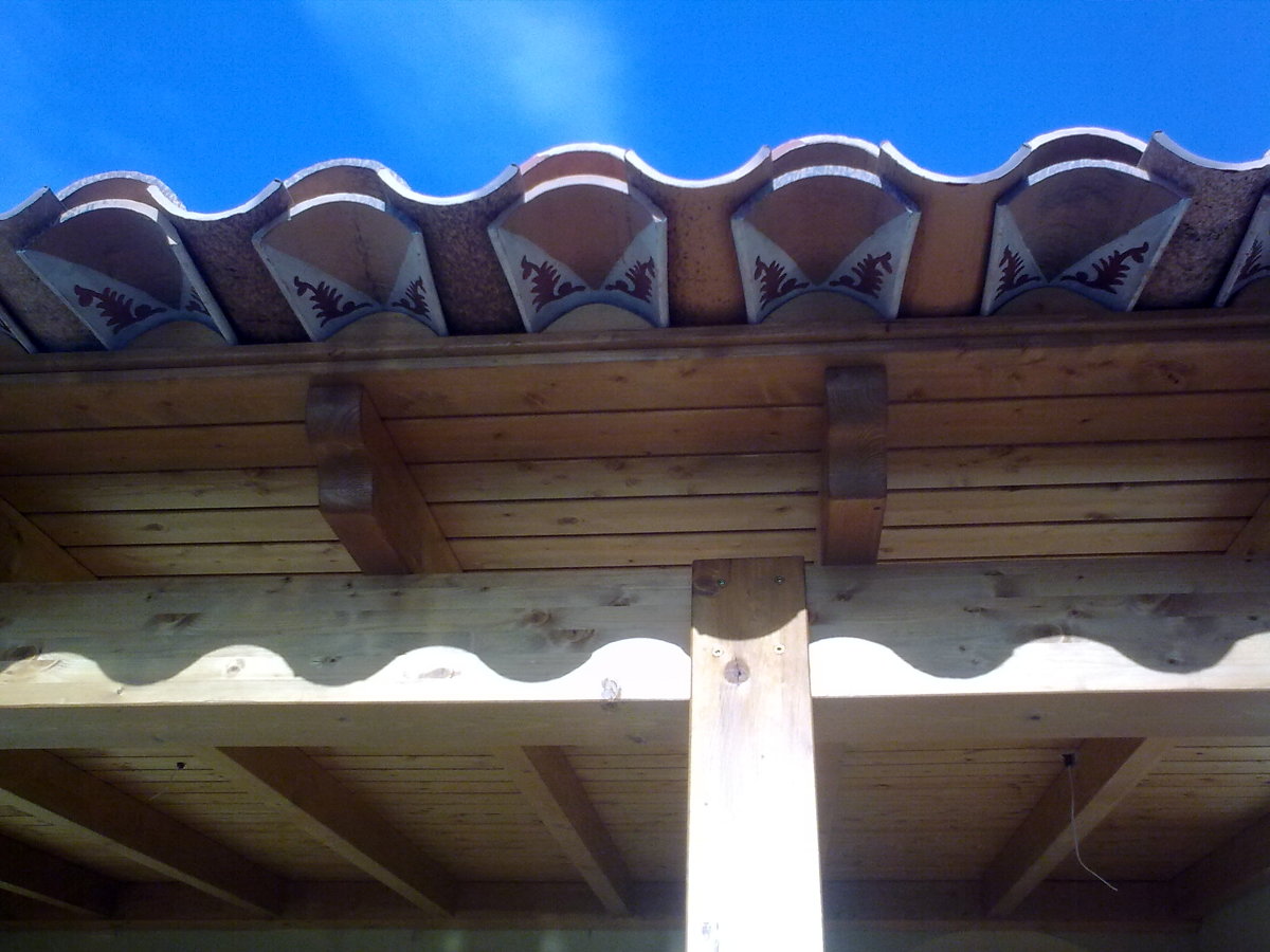 Detalle de alero con tejas decoradas.