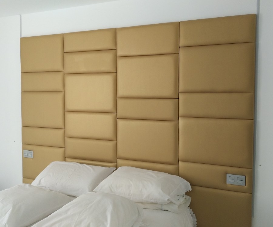 Cabecero en polipiel dorado a cuarterones