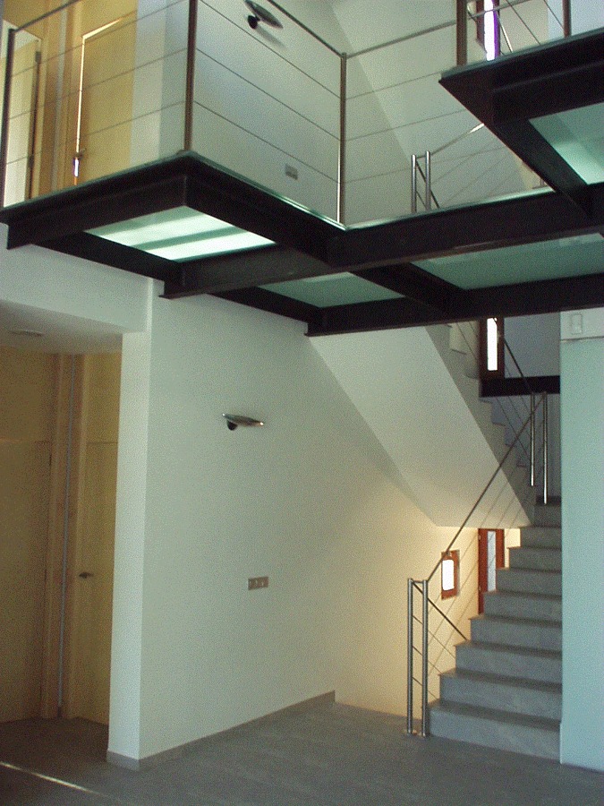 Vista de zona de escalera de cristal y hacero Inox