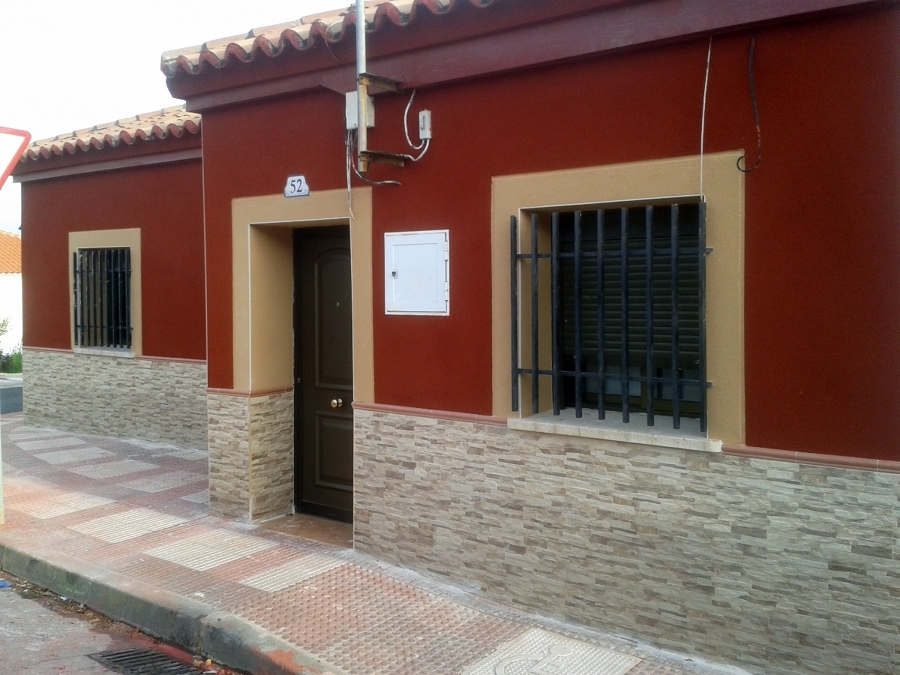 Zocalo en fachada con revestimiento en zona alta