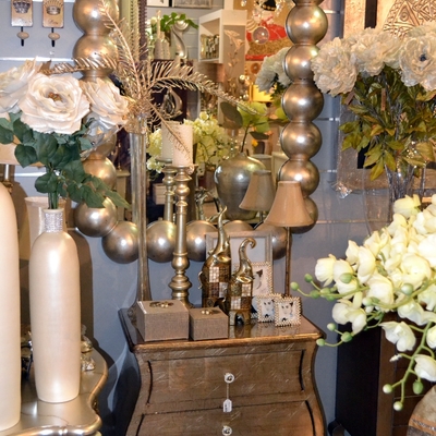 Espejo y mueble auxiliar en tonos dorados.