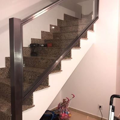 Barandilla de hierro pulido y cristal, barnizado al horno.