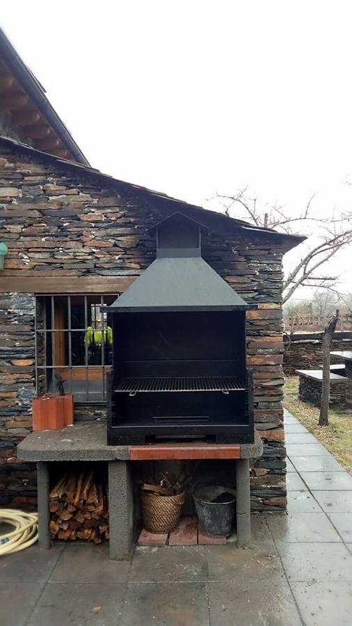 Barbacoa con base de piedra y hogar metalico