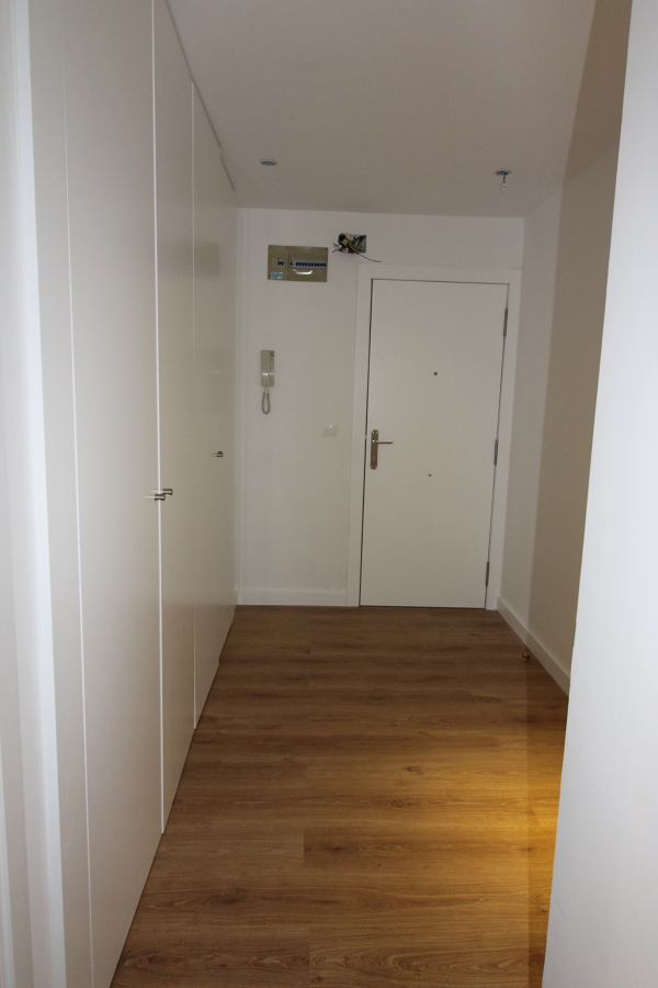 Entrada panelada con armarios