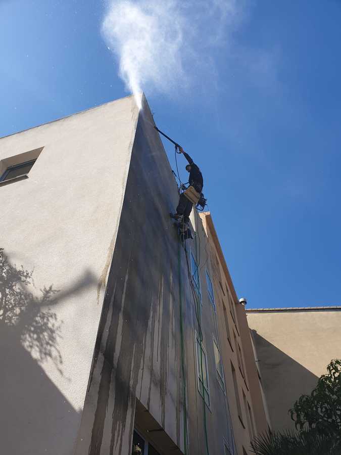 Limpieza de fachada con agua alta presión con posicionamiento con cuerda en trabajos verticales
