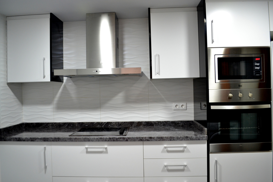 Gran Mampara extractora sobre encimera de granito.