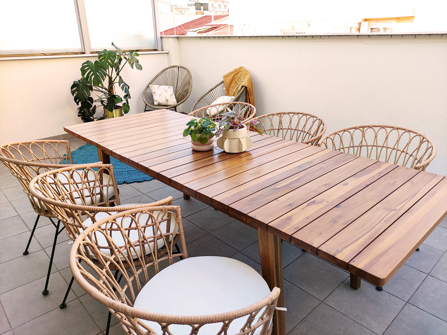 Terraza decorada con piezas en acabados naturales como maderas y fibras naturales.