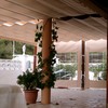 Pérgola de madera con toldo y cortinas tensadas