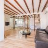 Salón con vigas en el techo y pilares de madera